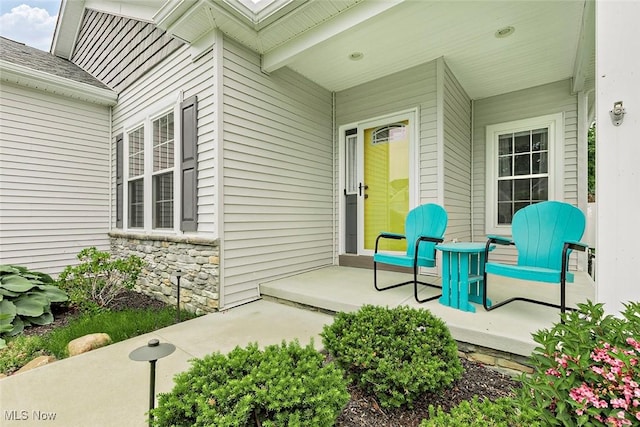 686 Outrigger Cv, Painesville, OH 44077 - view of exterior entry with covered porch and stone siding