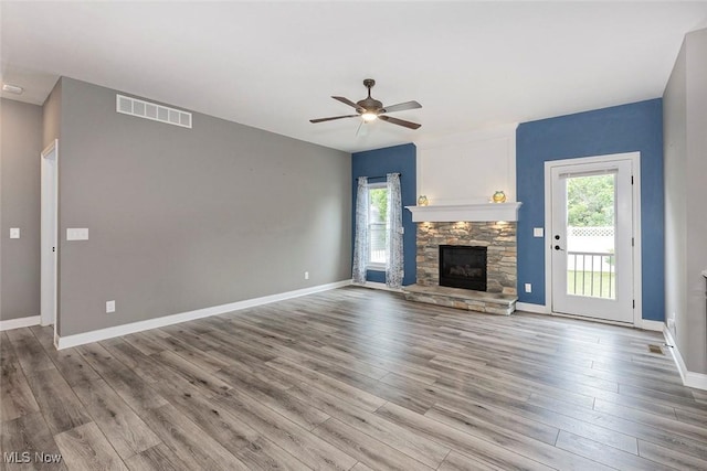 686 Outrigger Cv, Painesville, OH 44077 - unfurnished living room with a ceiling fan, wood finished floors, and a fireplace