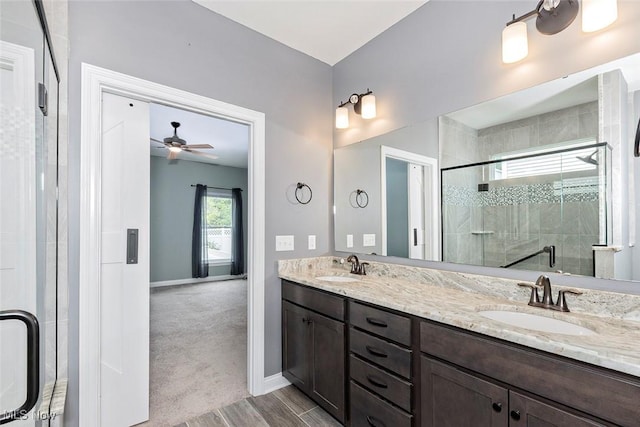 686 Outrigger Cv, Painesville, OH 44077 - full bathroom with a shower stall, double vanity, a ceiling fan, and wood finished floors