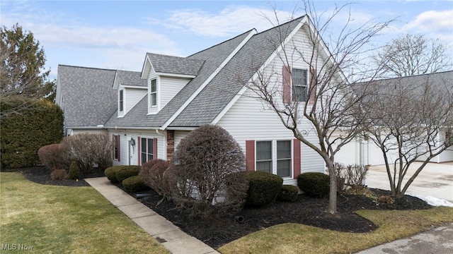 662 2nd St Unit 2, Fairport Harbor, OH 44077 - view of home's exterior with concrete driveway, a shingled roof, a garage, and a lawn