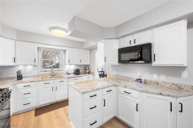 662 2nd St Unit 2, Fairport Harbor, OH 44077 - kitchen featuring black appliances, white cabinetry, and light wood-style flooring