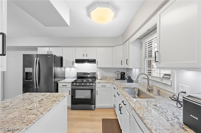 662 2nd St Unit 2, Fairport Harbor, OH 44077 - kitchen featuring stainless steel fridge with ice dispenser, gas range, under cabinet range hood, white cabinetry, and light stone countertops