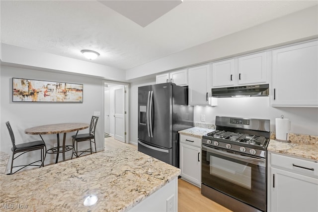 662 2nd St Unit 2, Fairport Harbor, OH 44077 - kitchen featuring range with gas cooktop, refrigerator with ice dispenser, under cabinet range hood, light wood-style flooring, and white cabinets