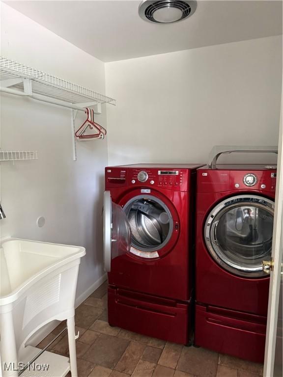 3726 Silvieus St, Ashtabula, OH 44004 - washroom featuring washing machine and clothes dryer and stone finish flooring