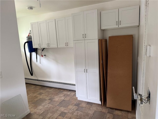 3726 Silvieus St, Ashtabula, OH 44004 - kitchen with a baseboard heating unit, stone finish floors, and white cabinets