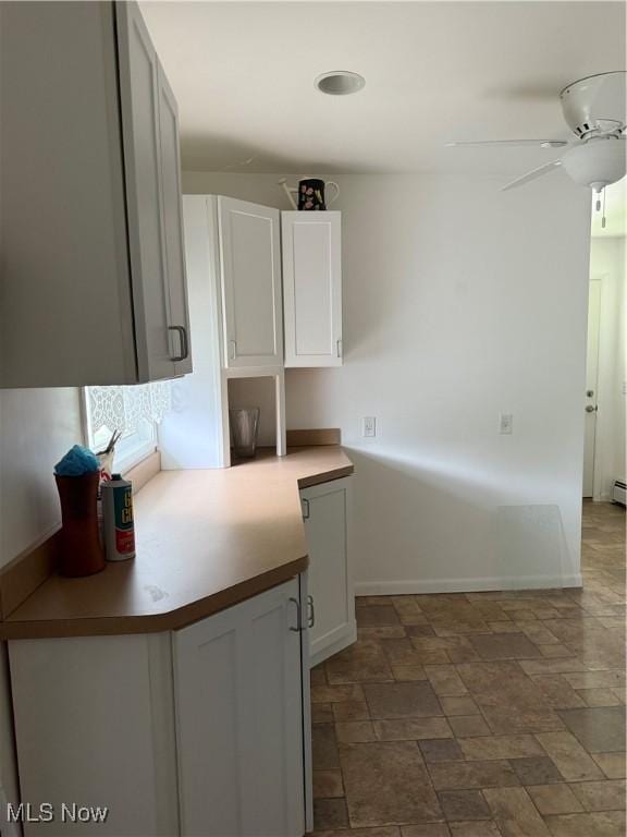 3726 Silvieus St, Ashtabula, OH 44004 - kitchen with ceiling fan, white cabinetry, and stone finish flooring