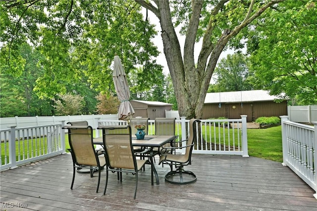 2847 Selkirk Bush Rd SW, Warren, OH 44481 - deck with outdoor dining area, an outdoor structure, and a fenced backyard