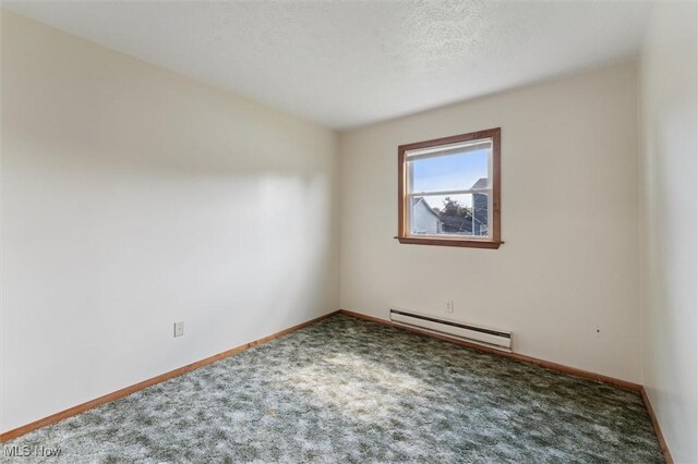 3917 Oxford Dr, Lorain, OH 44053 - spare room featuring a baseboard heating unit and carpet floors