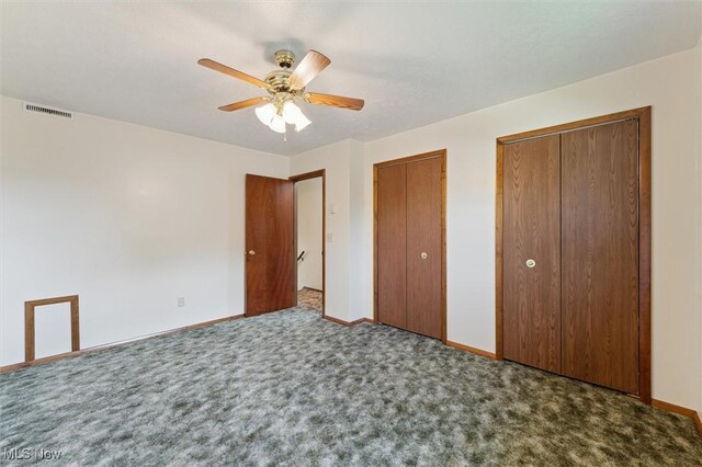 3917 Oxford Dr, Lorain, OH 44053 - unfurnished bedroom with two closets, carpet, and a ceiling fan