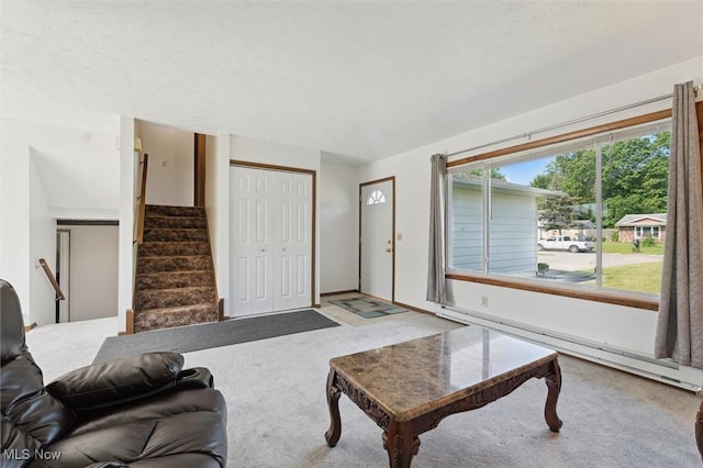 3917 Oxford Dr, Lorain, OH 44053 - living area featuring stairs, carpet, and a baseboard heating unit