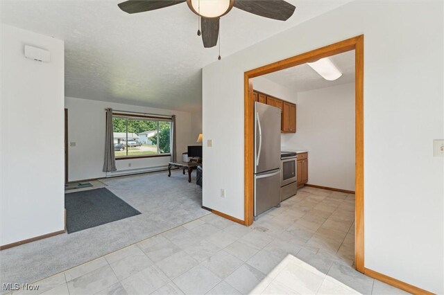 3917 Oxford Dr, Lorain, OH 44053 - kitchen with stainless steel appliances, brown cabinetry, light colored carpet, a ceiling fan, and open floor plan