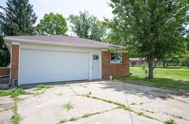 4029 Minard Rd NW, Dover, OH 44622 - view of front of house featuring brick siding, a garage, a front yard, and roof with shingles