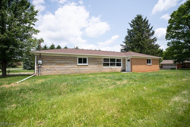 4029 Minard Rd NW, Dover, OH 44622 - back of property featuring a lawn and stone siding