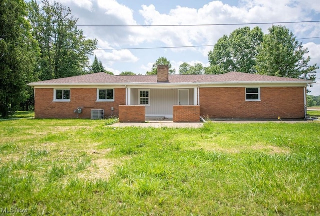 4029 Minard Rd NW, Dover, OH 44622 - rear view of property featuring brick siding, a lawn, and a chimney