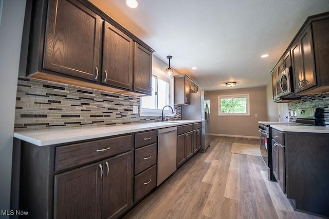 4029 Minard Rd NW, Dover, OH 44622 - kitchen featuring stainless steel appliances, decorative backsplash, light wood-style floors, light countertops, and recessed lighting