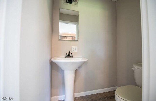 4029 Minard Rd NW, Dover, OH 44622 - bathroom featuring toilet and wood finished floors