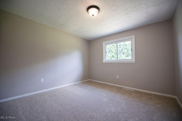 4029 Minard Rd NW, Dover, OH 44622 - carpeted empty room with a textured ceiling and baseboards