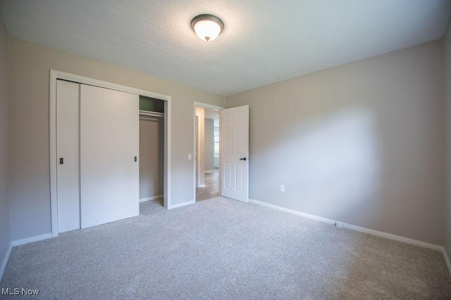 4029 Minard Rd NW, Dover, OH 44622 - unfurnished bedroom featuring carpet, a closet, and a textured ceiling
