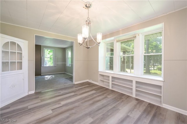 1057 Bloomfield Ave, Akron, OH 44302 - unfurnished dining area with a chandelier and wood finished floors