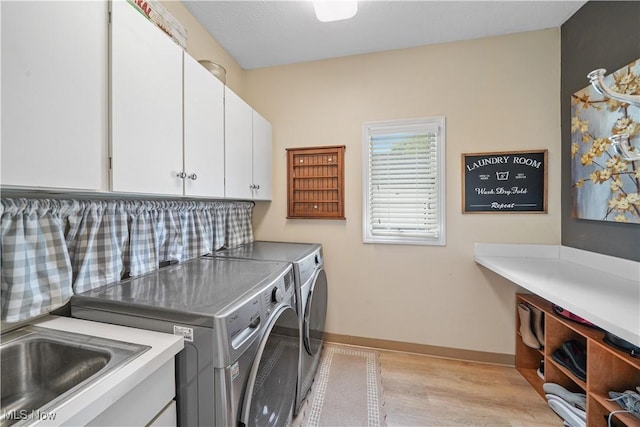 196 Chisholm Ct, Aurora, OH 44202 - laundry area with cabinet space, washer and dryer, and light wood-style flooring