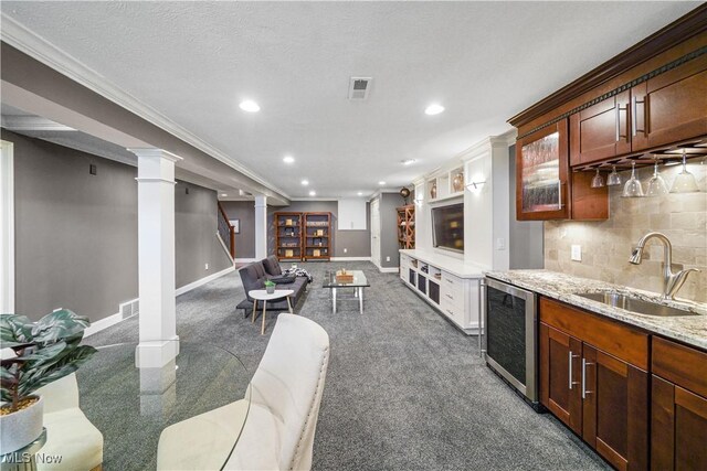 196 Chisholm Ct, Aurora, OH 44202 - kitchen featuring wine cooler, recessed lighting, open floor plan, tasteful backsplash, and decorative columns