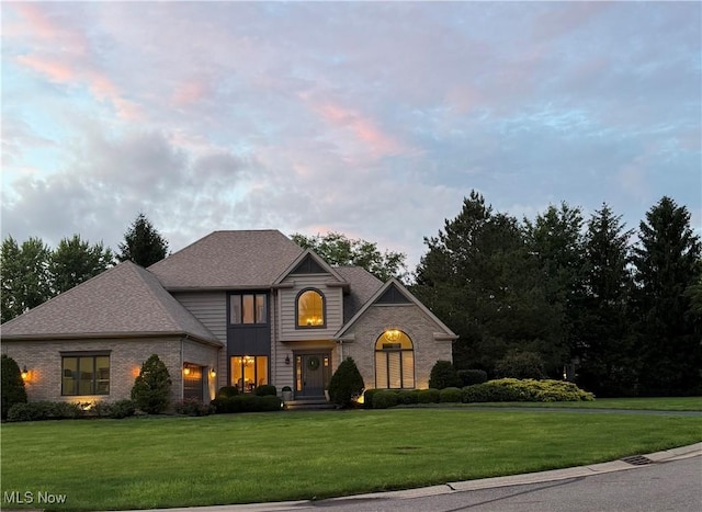 196 Chisholm Ct, Aurora, OH 44202 - traditional-style home featuring a front lawn, brick siding, and a garage