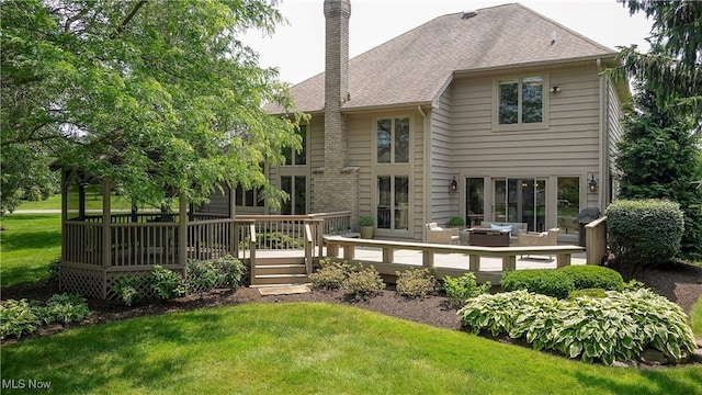 196 Chisholm Ct, Aurora, OH 44202 - rear view of property with a chimney, a lawn, a deck, and roof with shingles