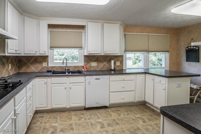 525 Marquardt Ave NE, North Canton, OH 44720 - kitchen with white dishwasher, white cabinetry, a textured ceiling, tasteful backsplash, and dark countertops