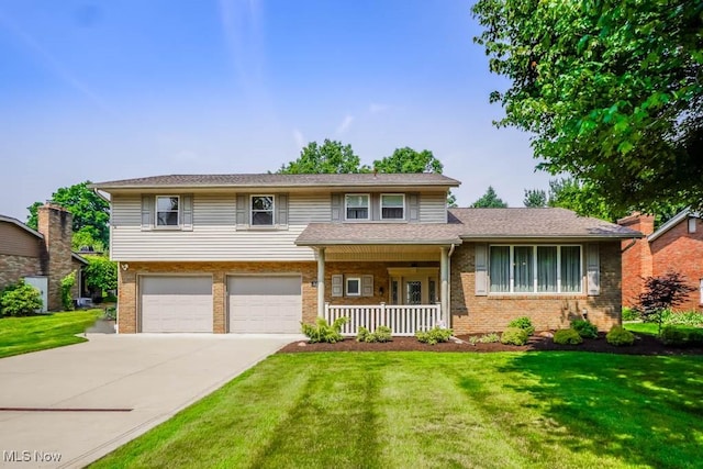 525 Marquardt Ave NE, North Canton, OH 44720 - view of front of home featuring brick siding, a porch, driveway, and a front lawn