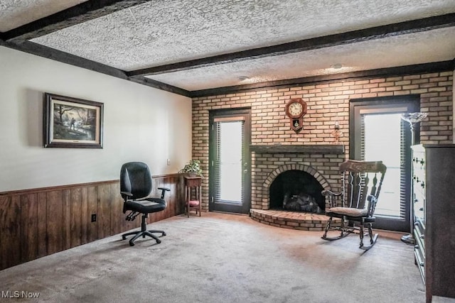 525 Marquardt Ave NE, North Canton, OH 44720 - living area with carpet floors, beamed ceiling, a wainscoted wall, a brick fireplace, and wood walls