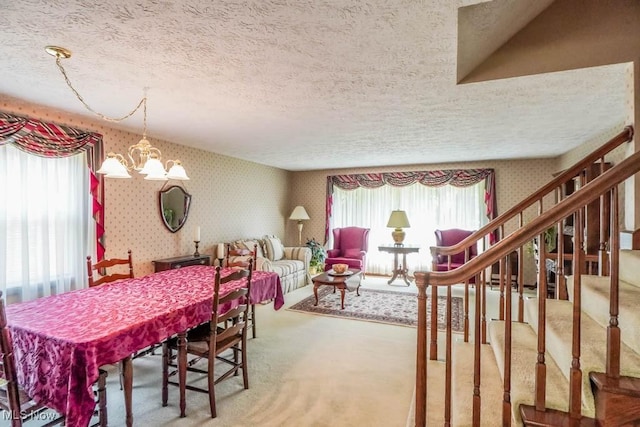 525 Marquardt Ave NE, North Canton, OH 44720 - carpeted dining area with wallpapered walls, a textured ceiling, and a chandelier