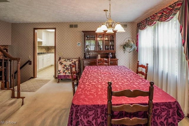 525 Marquardt Ave NE, North Canton, OH 44720 - dining space with wallpapered walls, light carpet, a chandelier, a textured ceiling, and stairway