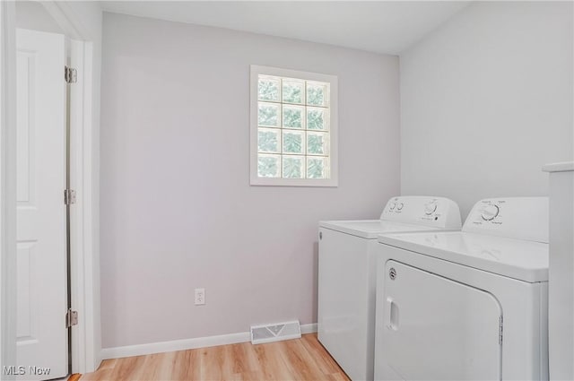 935 Portage Lakes Dr, Coventry Township, OH 44319 - washroom with washing machine and clothes dryer and light wood-type flooring
