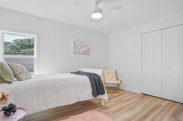 935 Portage Lakes Dr, Coventry Township, OH 44319 - bedroom with wood finished floors, a closet, and a ceiling fan