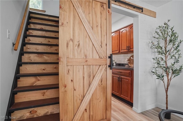 935 Portage Lakes Dr, Coventry Township, OH 44319 - stairs featuring a barn door and wood finished floors