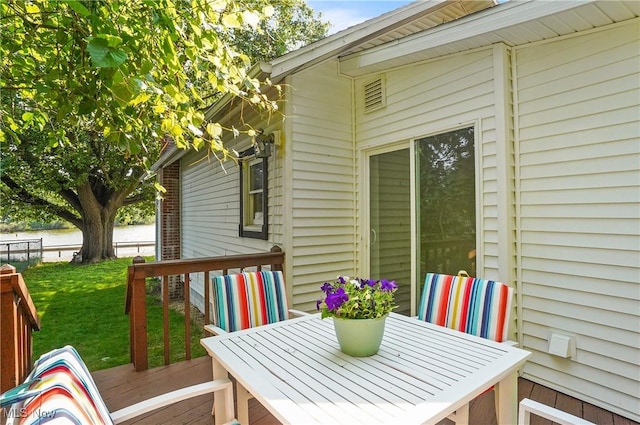 935 Portage Lakes Dr, Coventry Township, OH 44319 - wooden terrace with a lawn and outdoor dining area