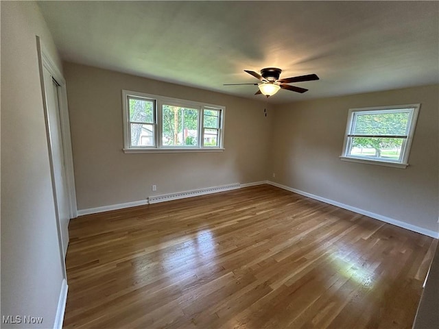7295 Clovermeade Ave, Poland, OH 44514 - unfurnished bedroom featuring a baseboard heating unit, wood finished floors, a closet, and a ceiling fan