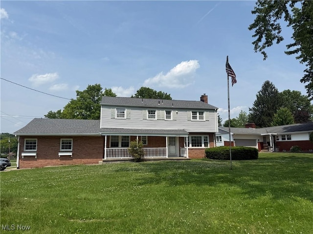 3022 Heatherbrae Dr, Poland, OH 44514 - colonial-style house with a porch, brick siding, a chimney, and a front yard