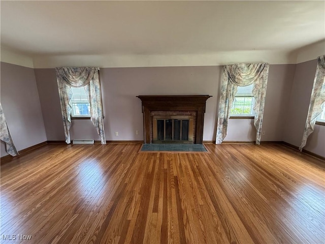 3022 Heatherbrae Dr, Poland, OH 44514 - unfurnished living room featuring wood finished floors and a glass covered fireplace