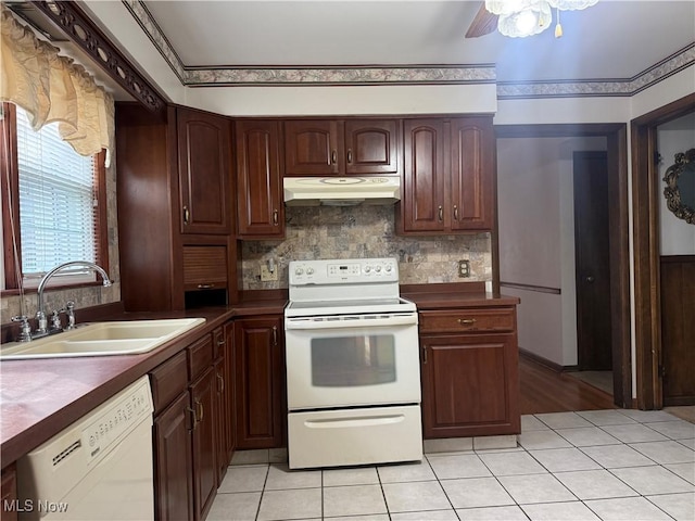 3022 Heatherbrae Dr, Poland, OH 44514 - kitchen featuring white appliances, under cabinet range hood, decorative backsplash, and light tile patterned flooring