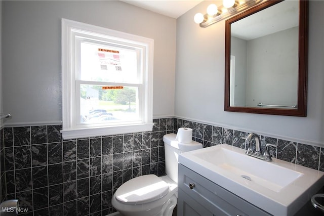 230 E 242nd St, Euclid, OH 44123 - half bath featuring tile walls, vanity, and a wainscoted wall