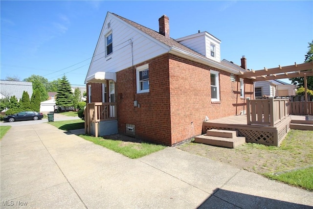 230 E 242nd St, Euclid, OH 44123 - view of side of property featuring brick siding, a deck, a chimney, and a pergola