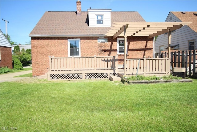 230 E 242nd St, Euclid, OH 44123 - rear view of house with brick siding, a lawn, a wooden deck, and a pergola