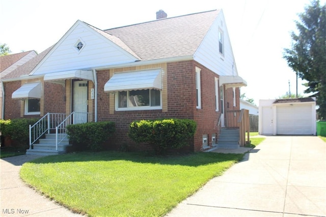 230 E 242nd St, Euclid, OH 44123 - bungalow-style house with brick siding, a front yard, an outbuilding, and roof with shingles