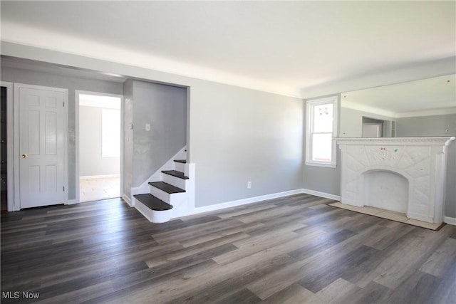230 E 242nd St, Euclid, OH 44123 - unfurnished living room with wood finished floors, stairway, and a high end fireplace