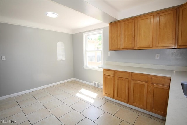 230 E 242nd St, Euclid, OH 44123 - kitchen with light countertops, brown cabinets, and light tile patterned flooring
