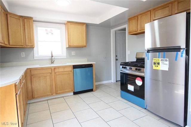 230 E 242nd St, Euclid, OH 44123 - kitchen with appliances with stainless steel finishes, light countertops, light tile patterned floors, and light brown cabinetry
