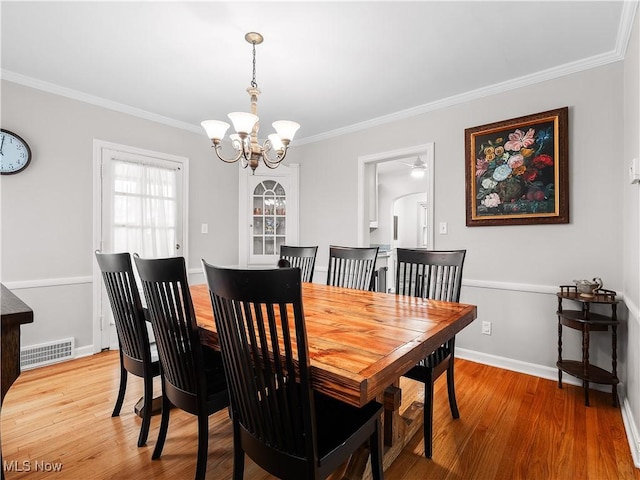 3845 Hillbrook Rd, University Heights, OH 44118 - dining room featuring ornamental molding, a chandelier, and light wood-type flooring