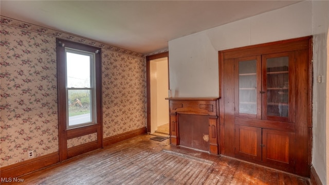 59590 Vocational Rd, Byesville, OH 43723 - unfurnished living room featuring wood finished floors and wallpapered walls