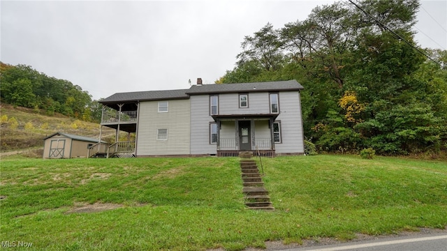 59590 Vocational Rd, Byesville, OH 43723 - view of front of property featuring a storage unit, stairs, a front yard, a chimney, and covered porch